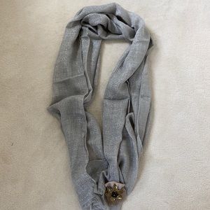 Shimmer scarf with floral accessory